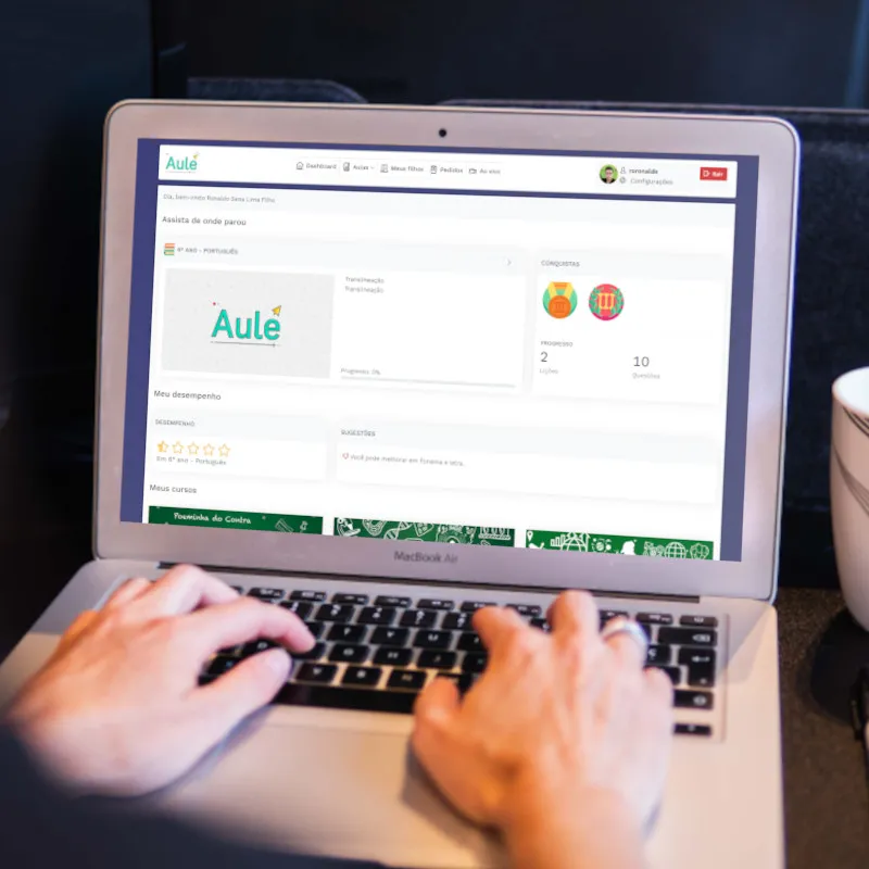 Laptop showing the Aulé platform dashboard